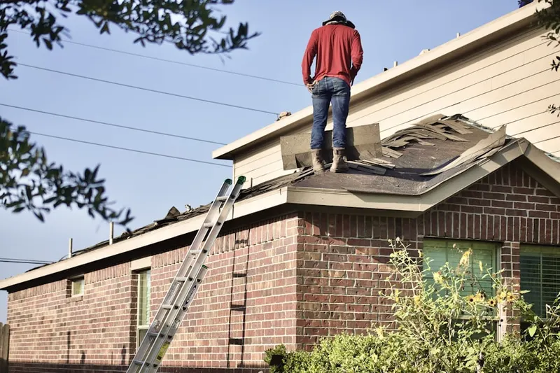 Professional roofer working on a residential roof in Roxbury Station